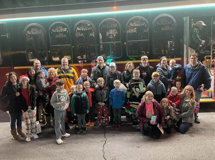 Big group posing in front of a trolley
