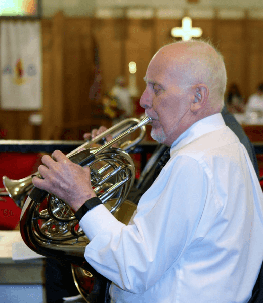 Church goer playing french horn